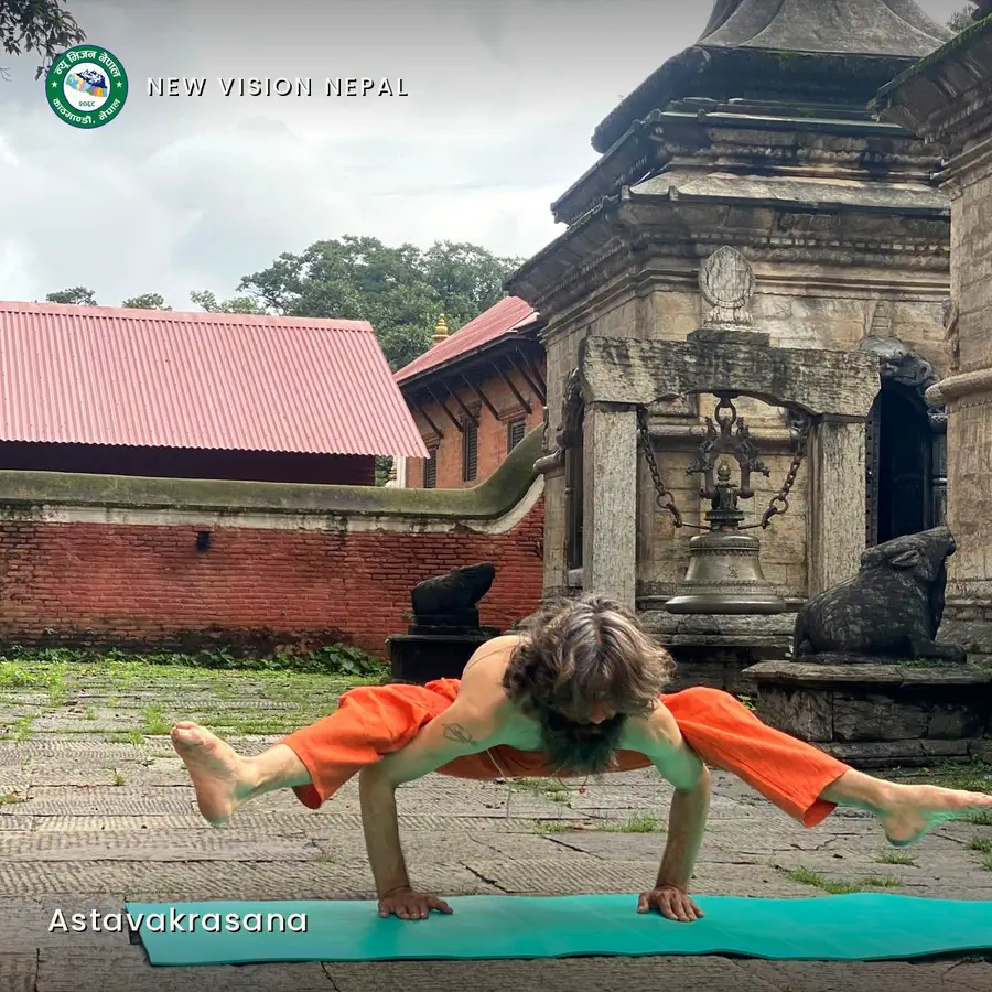 Yogi Ji held horizontal on two hands, the legs wound and extended to either side, before a bell shrine at Pashupatinath.