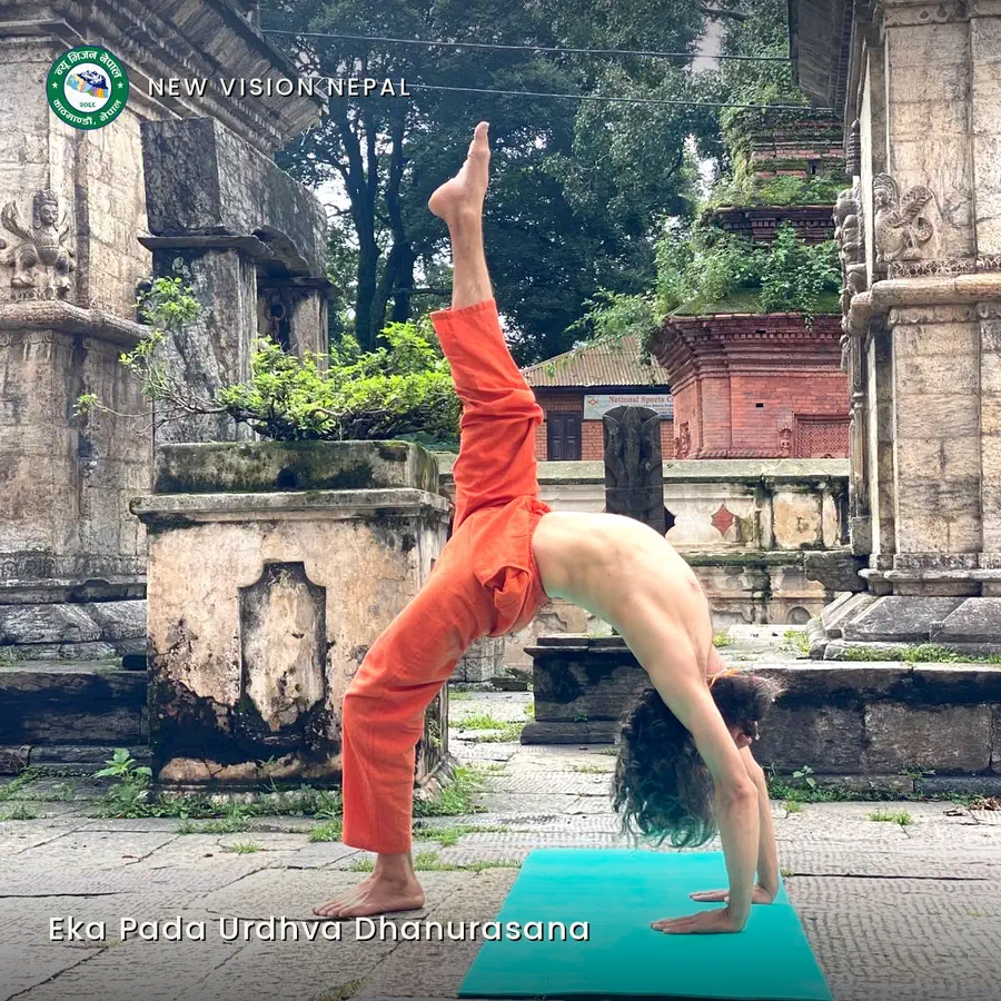 Yogi Ji in an upward bow with one leg lifted straight above him, among the stone and brick shrines of the temple grounds.